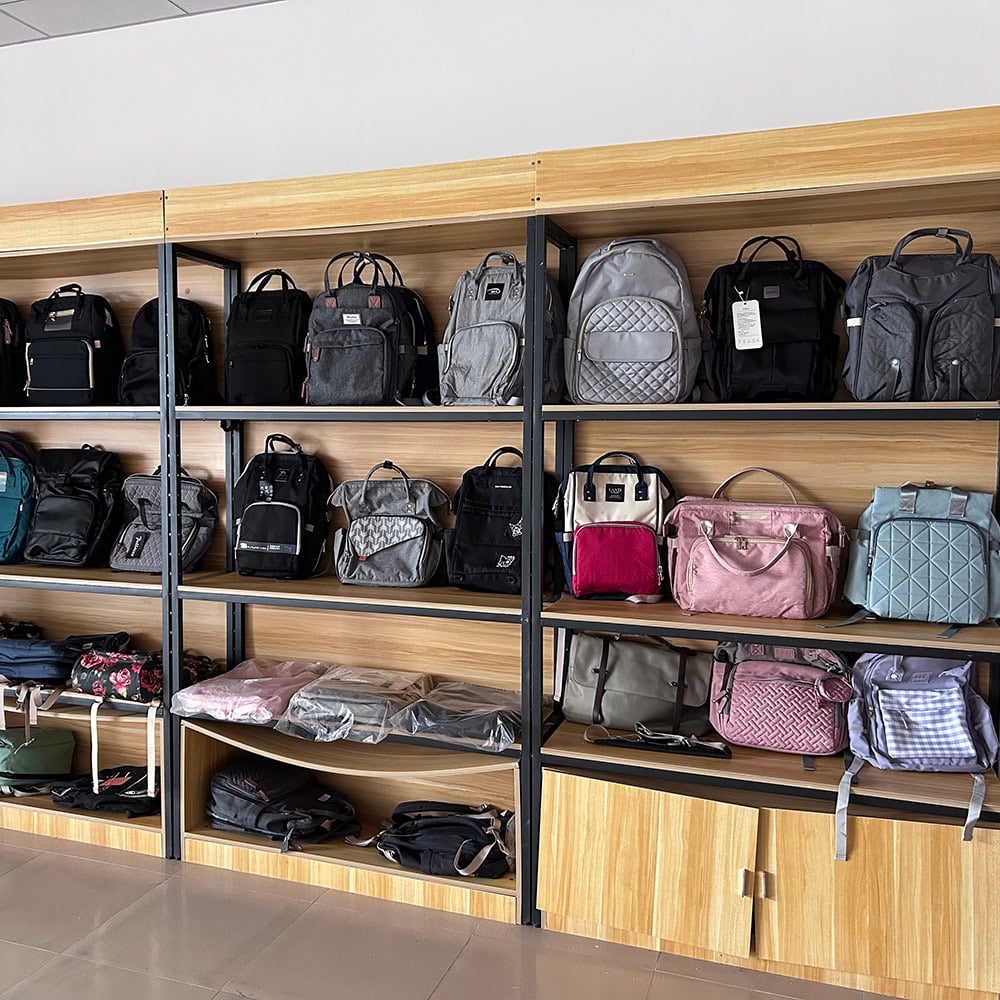 A room with many bags and purses on shelves.
